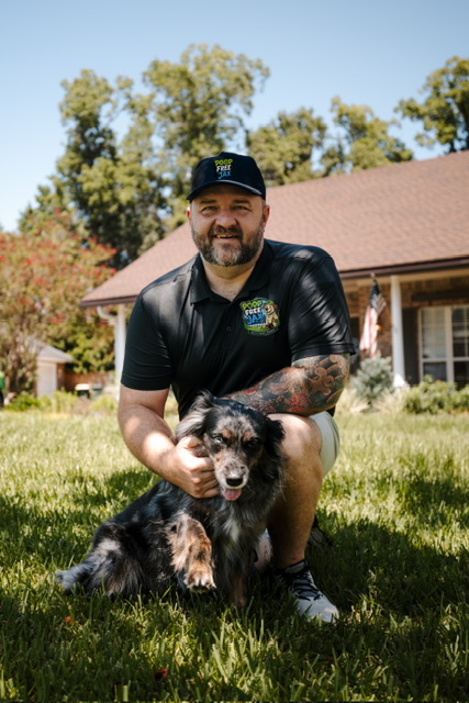 Poop Free Jax owner with his dog in a Jacksonville backyard